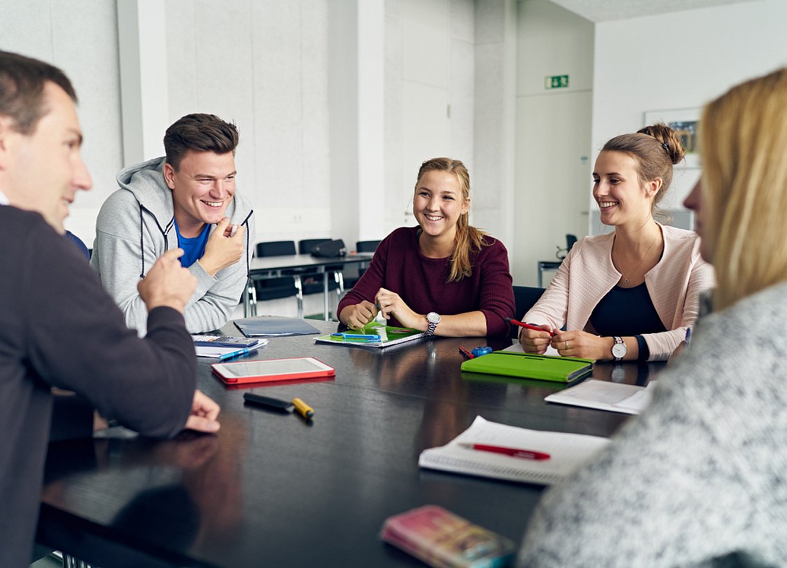 Eine Gruppe Studierender in einem Seminarraum